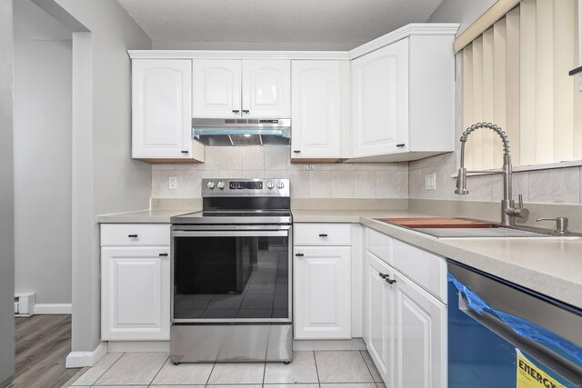 1400 Meriden Rd Apt 1-2, Waterbury, CT 06705 - kitchen featuring under cabinet range hood, stainless steel electric range, dishwasher, a sink, and white cabinets