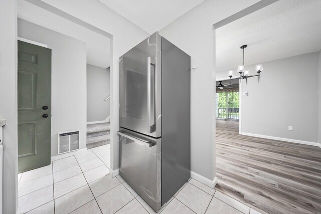 1400 Meriden Rd Apt 1-2, Waterbury, CT 06705 - kitchen with freestanding refrigerator, baseboards, a chandelier, and light wood-type flooring
