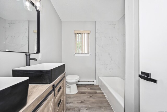 1400 Meriden Rd Apt 1-2, Waterbury, CT 06705 - bathroom featuring a baseboard radiator, vanity, toilet, wood finished floors, and washtub / shower combination