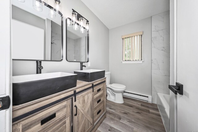 1400 Meriden Rd Apt 1-2, Waterbury, CT 06705 - full bathroom featuring a baseboard heating unit, double vanity, toilet, and wood finished floors