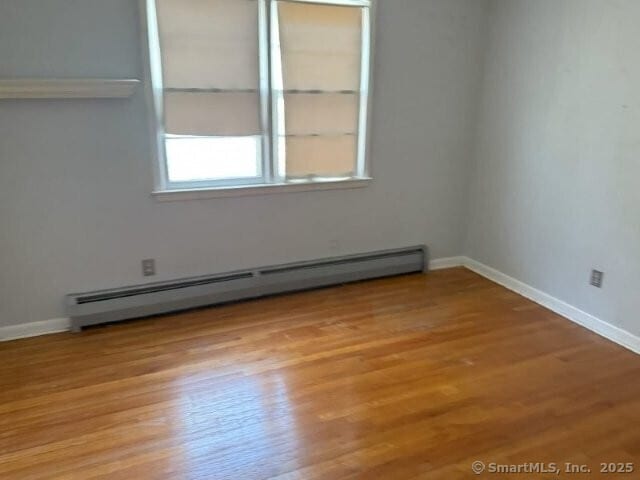 6 Spencer Pl, New Haven, CT 06515 - spare room with a baseboard radiator, wood finished floors, and baseboards