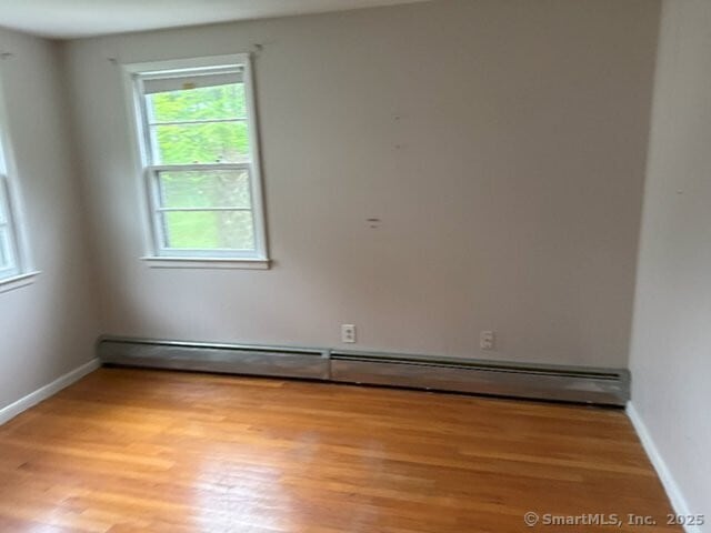 6 Spencer Pl, New Haven, CT 06515 - spare room with baseboard heating, light wood-type flooring, and baseboards