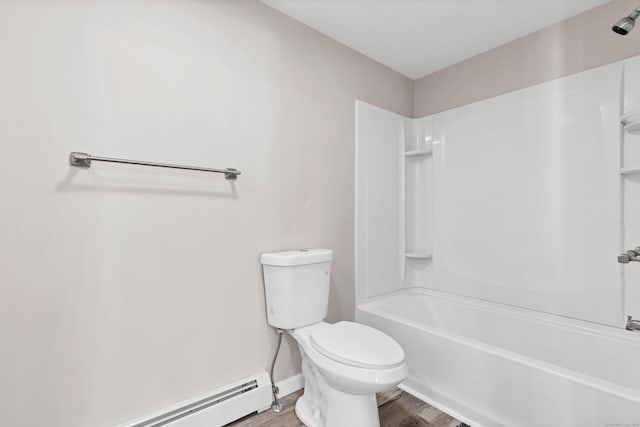 bathroom featuring a baseboard heating unit, wood finished floors, toilet, washtub / shower combination, and baseboards
