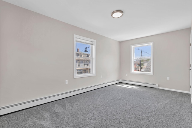 carpeted spare room with baseboards and baseboard heating