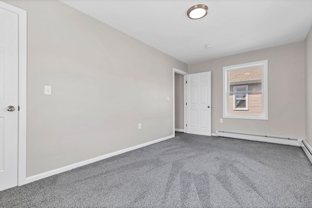 empty room with carpet floors, baseboards, and a baseboard heating unit