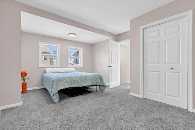 carpeted bedroom featuring baseboards