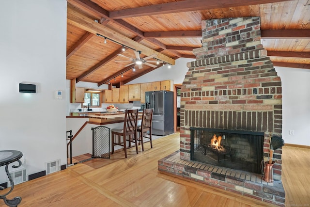 6 Knorr Rd, Oxford, CT 06478 - living room with wood ceiling, light wood-style floors, a brick fireplace, baseboards, and ceiling fan