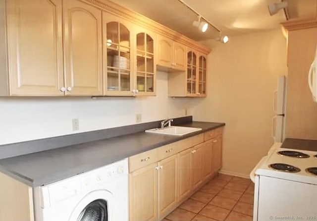 245 Unquowa Rd Apt 127, Fairfield, CT 06824 - kitchen featuring white appliances, a sink, washer / clothes dryer, dark countertops, and track lighting