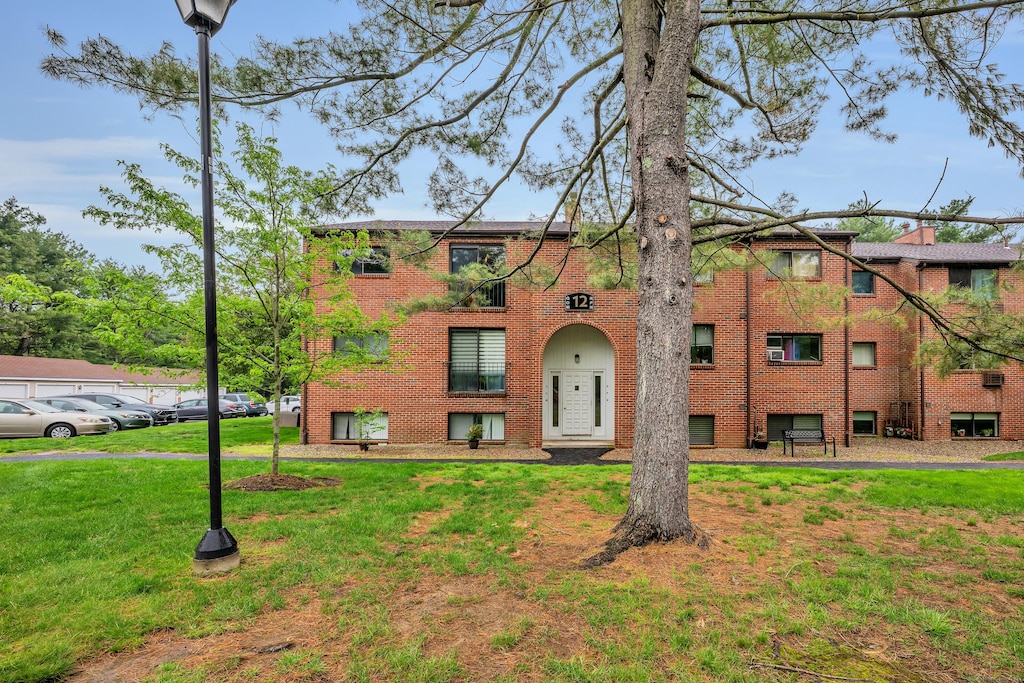 12 Darling St Apt N, Southington, CT 06489 - view of front of home with brick siding and a front lawn