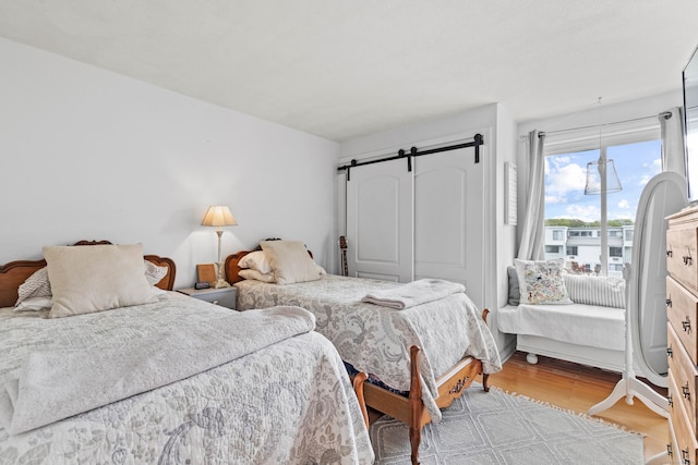 18 Hamre Ln Unit B, Branford, CT 06405 - bedroom with wood finished floors and a barn door