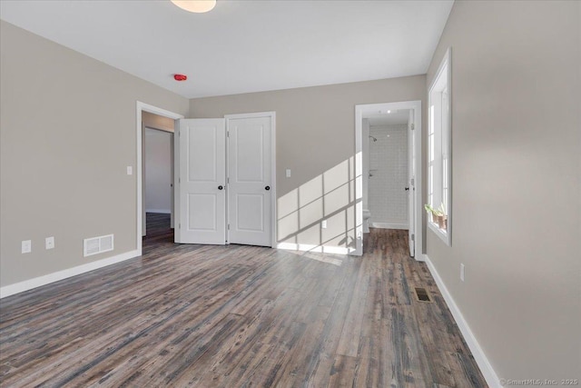 unfurnished bedroom featuring wood finished floors and baseboards