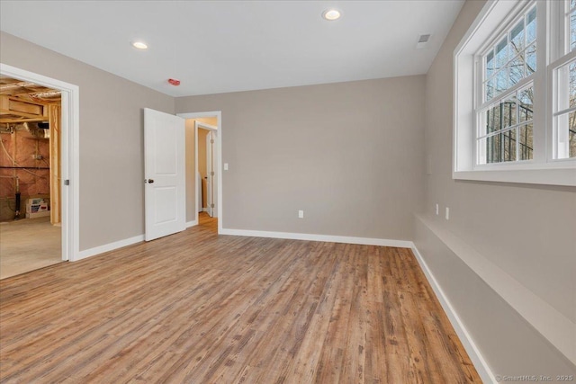 unfurnished bedroom with baseboards, light wood-type flooring, and recessed lighting