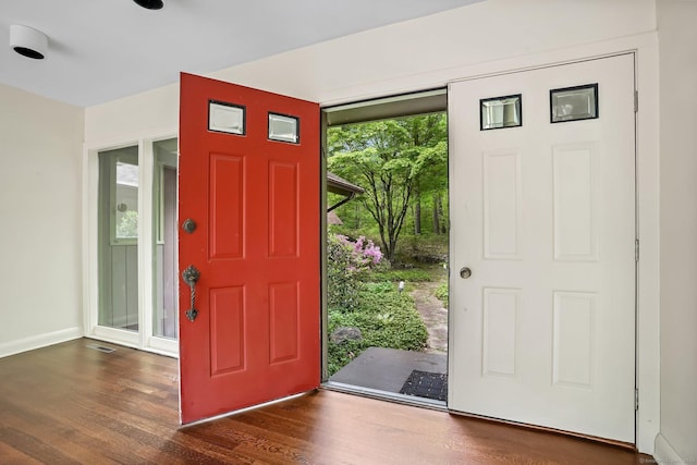 entryway with wood finished floors and baseboards