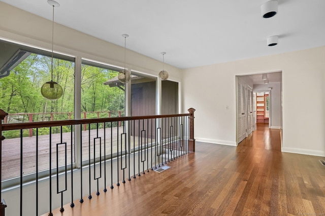 empty room featuring baseboards and wood finished floors