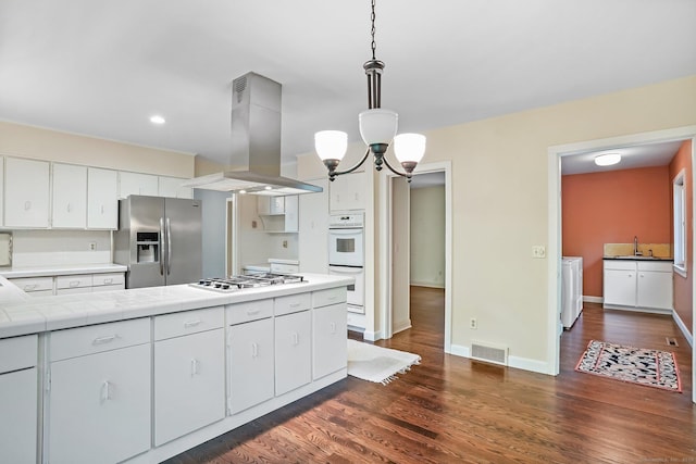 61 Stony Brook Rd, Middlebury, CT 06762 - kitchen featuring white appliances, island range hood, tile counters, a chandelier, and dark wood-style flooring