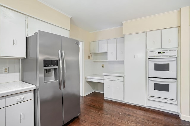 61 Stony Brook Rd, Middlebury, CT 06762 - kitchen with stainless steel fridge, double oven, dark wood-style flooring, crown molding, and tile counters