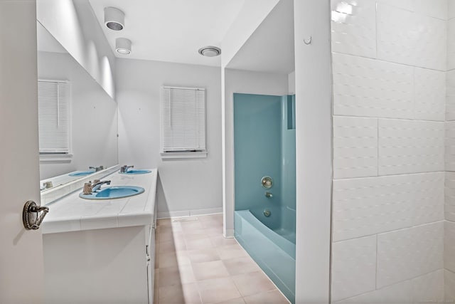 full bath featuring vanity, baseboards, and shower / tub combination
