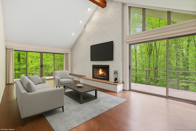 61 Stony Brook Rd, Middlebury, CT 06762 - living room featuring high vaulted ceiling, beam ceiling, a brick fireplace, wood finished floors, and recessed lighting