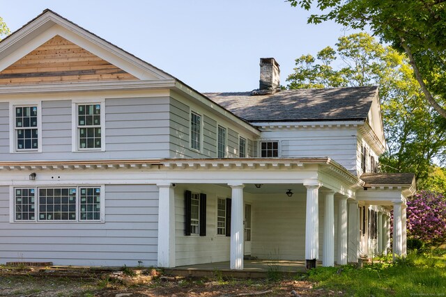 134 Roxbury Rd, Washington, CT 06793 - rear view of house featuring a chimney and a porch