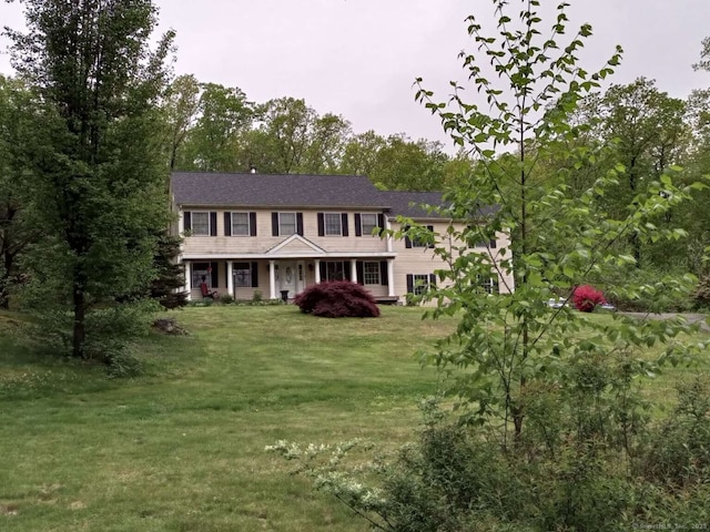 colonial-style house with a front yard