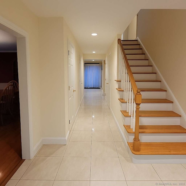 hall with tile patterned flooring, stairway, recessed lighting, and baseboards