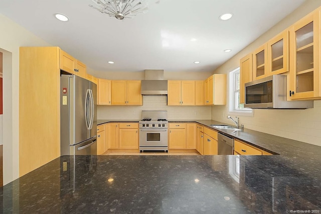 kitchen with appliances with stainless steel finishes, light brown cabinets, a sink, wall chimney range hood, and recessed lighting