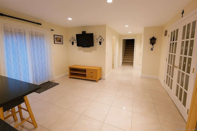 hall featuring stairway, recessed lighting, light tile patterned flooring, and baseboards