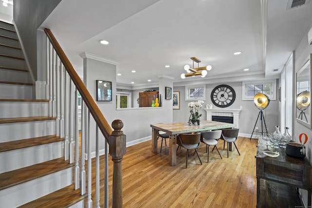 3 Arrowhead Rd, Madison, CT 06443 - dining room featuring a fireplace, stairway, light wood finished floors, baseboards, and recessed lighting