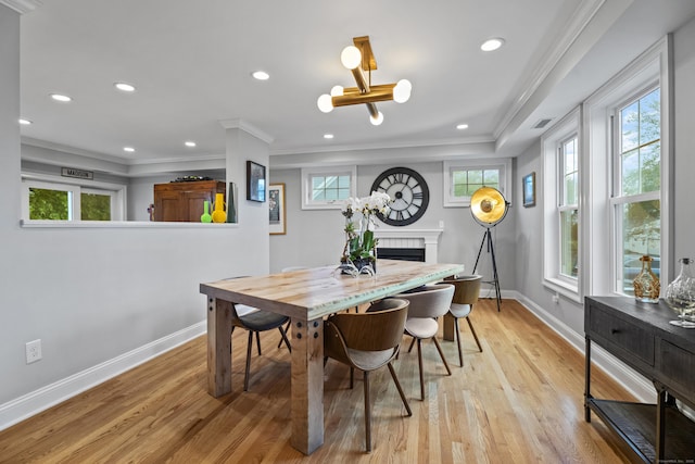 3 Arrowhead Rd, Madison, CT 06443 - dining area featuring a fireplace, healthy amount of natural light, light wood finished floors, crown molding, and recessed lighting