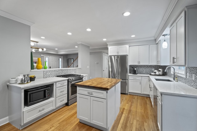 3 Arrowhead Rd, Madison, CT 06443 - kitchen with appliances with stainless steel finishes, wooden counters, a sink, crown molding, and backsplash
