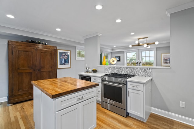 3 Arrowhead Rd, Madison, CT 06443 - kitchen with high end stainless steel range, wooden counters, crown molding, white cabinets, and light wood-style floors