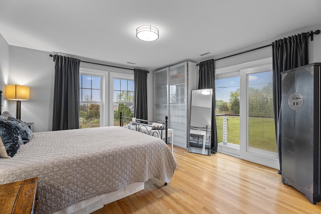 3 Arrowhead Rd, Madison, CT 06443 - bedroom featuring multiple windows, light wood-type flooring, and access to exterior