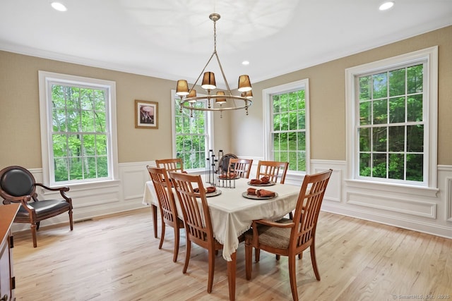 18 Beaver Dam Rd, Newtown, CT 06470 - dining area featuring a chandelier, plenty of natural light, a wainscoted wall, light wood-type flooring, and a decorative wall