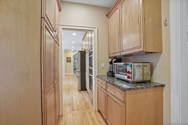 18 Beaver Dam Rd, Newtown, CT 06470 - kitchen with light wood-style flooring, freestanding refrigerator, recessed lighting, light brown cabinets, and dark stone countertops