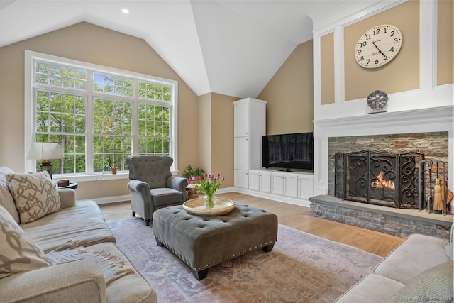 18 Beaver Dam Rd, Newtown, CT 06470 - living room featuring a stone fireplace, light wood-style floors, vaulted ceiling, and baseboards