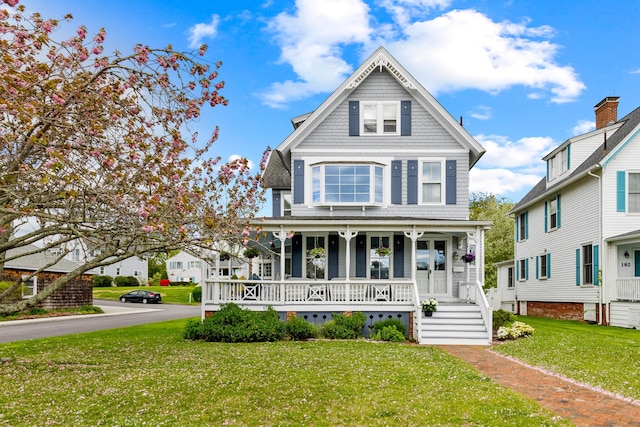 178 Shore Ave, Groton, CT 06340 - victorian-style house featuring covered porch and a front lawn