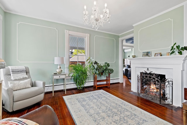 178 Shore Ave, Groton, CT 06340 - living room featuring hardwood / wood-style flooring, crown molding, a chandelier, a wall mounted AC, and a fireplace with flush hearth