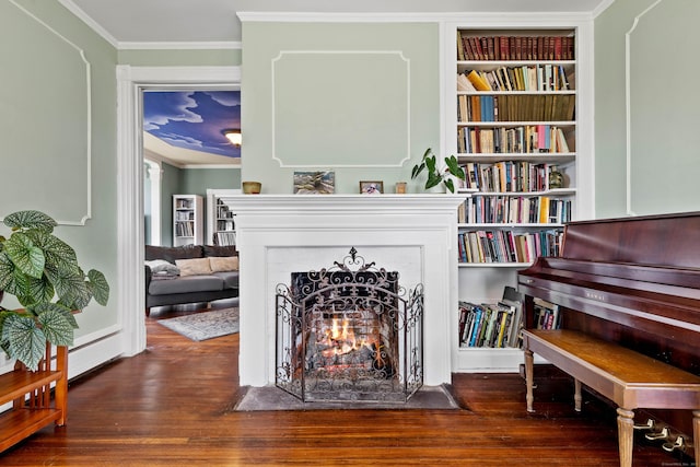 178 Shore Ave, Groton, CT 06340 - sitting room featuring a fireplace with flush hearth, wood finished floors, crown molding, and built in shelves