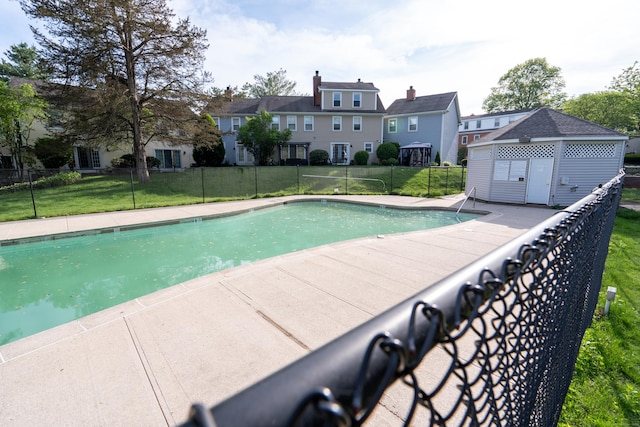 1 E Hayestown Rd Unit 24, Danbury, CT 06811 - view of swimming pool featuring an outdoor structure, a patio area, and a residential view