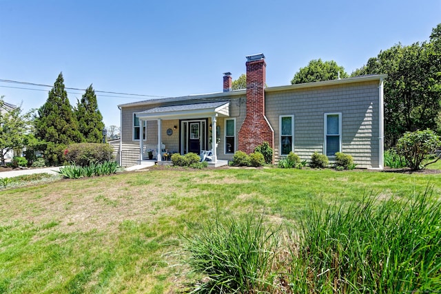 5 Quarry Rd, Stonington, CT 06355 - view of front of house with a chimney, a front lawn, and covered porch