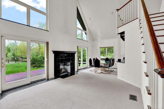 233 N Society Rd, Canterbury, CT 06331 - entrance foyer with high vaulted ceiling, a fireplace, stairway, carpet floors, and baseboards