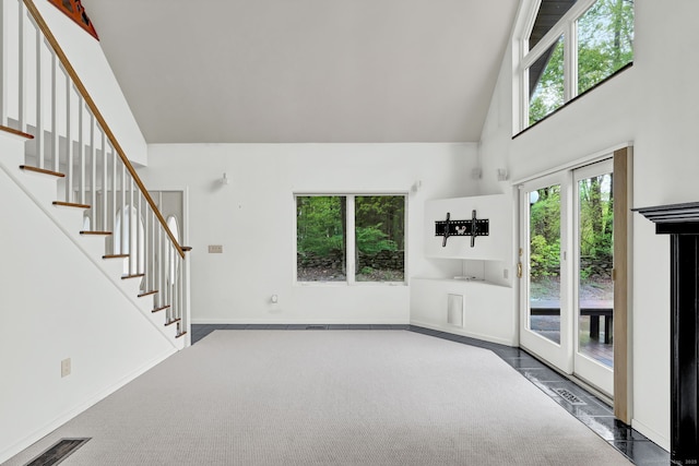 233 N Society Rd, Canterbury, CT 06331 - unfurnished living room featuring high vaulted ceiling, stairs, carpet flooring, and baseboards