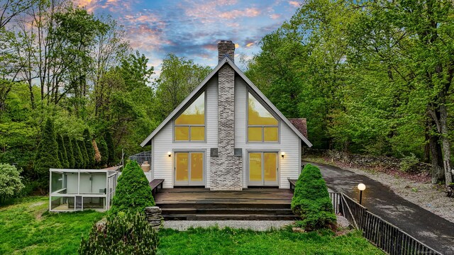 233 N Society Rd, Canterbury, CT 06331 - back of house at dusk featuring a chimney and a deck