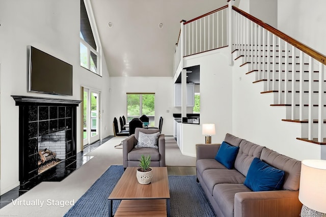 233 N Society Rd, Canterbury, CT 06331 - living room featuring high vaulted ceiling, a tiled fireplace, and stairs