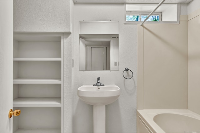 233 N Society Rd, Canterbury, CT 06331 - full bath with a bathtub, built in shelves, and a textured wall