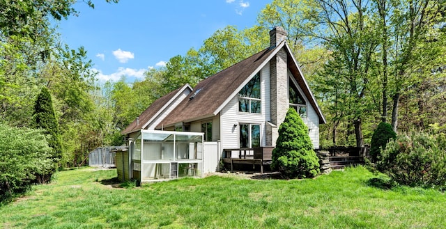 233 N Society Rd, Canterbury, CT 06331 - back of house with a yard, a wooden deck, a chimney, an outbuilding, and a shingled roof