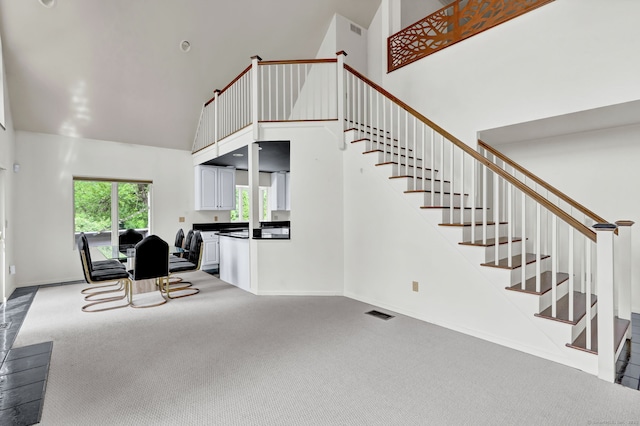 233 N Society Rd, Canterbury, CT 06331 - unfurnished living room featuring high vaulted ceiling, carpet, stairway, and baseboards