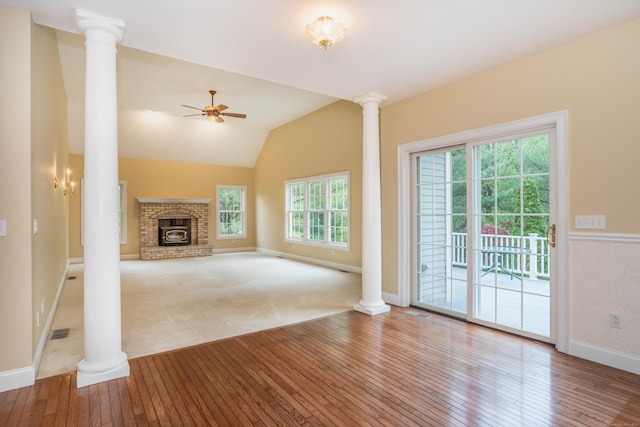unfurnished living room featuring decorative columns, wood-type flooring, a ceiling fan, and lofted ceiling