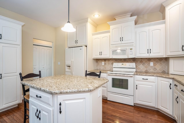 kitchen with white appliances, dark wood-type flooring, a kitchen island, decorative backsplash, and recessed lighting