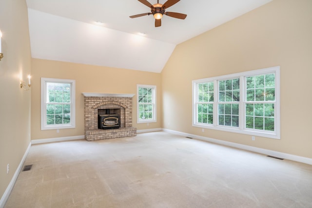 unfurnished living room with ceiling fan, carpet, baseboards, lofted ceiling, and a brick fireplace